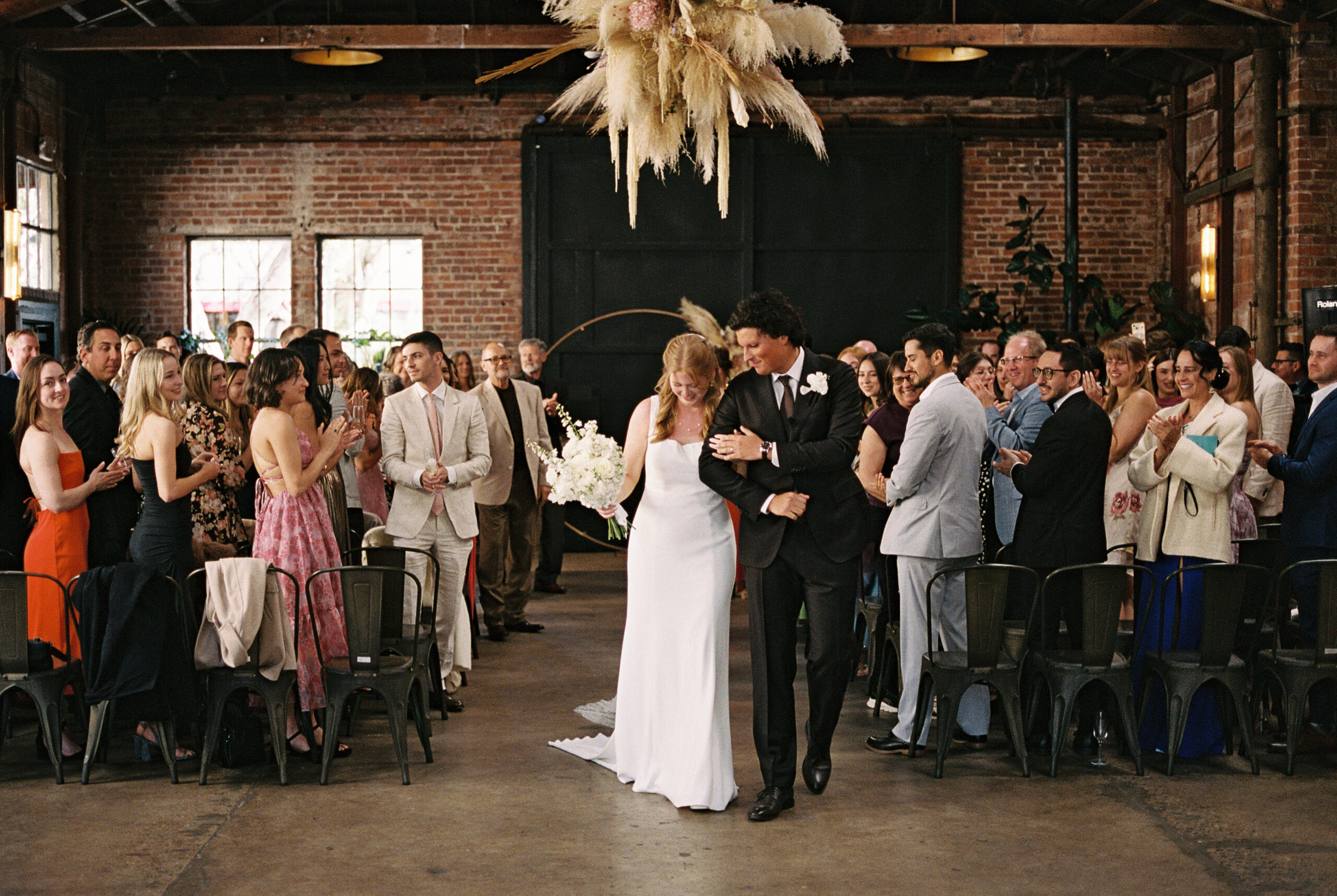 Couple walks down the aisle after wedding ceremony at The Penny.